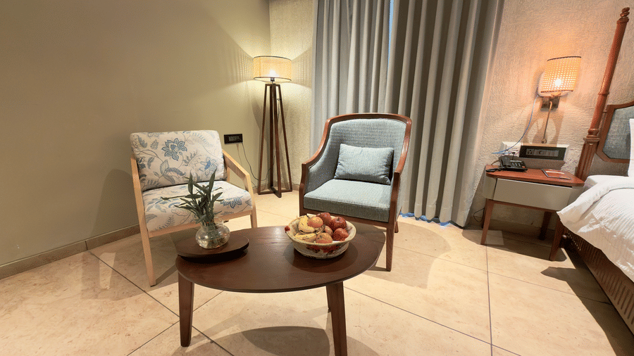  Vinti Resort villa room seating area with two armchairs and a round coffee table