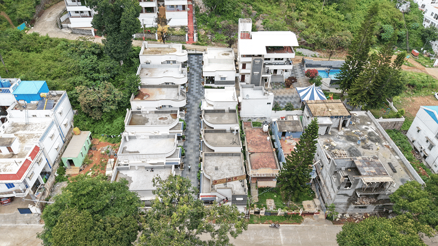 Closely arranged multi-story residential buildings and roads. | WOW Naturefull Resorts, Yercaud