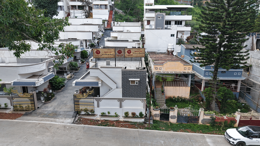 Closely arranged multi-story residential buildings and roads. | WOW Naturefull Resorts, Yercaud