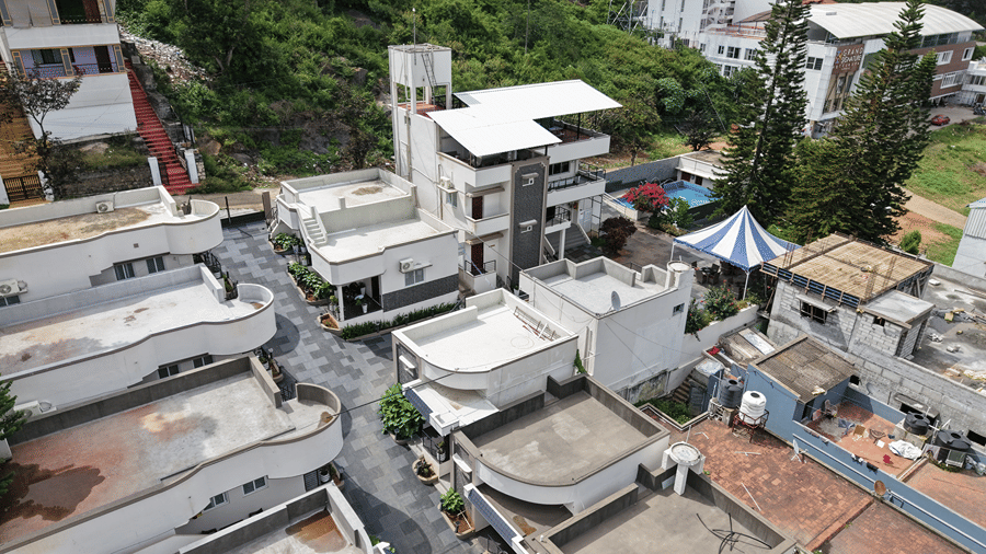 Closely arranged multi-story residential buildings and roads. | WOW Naturefull Resorts, Yercaud