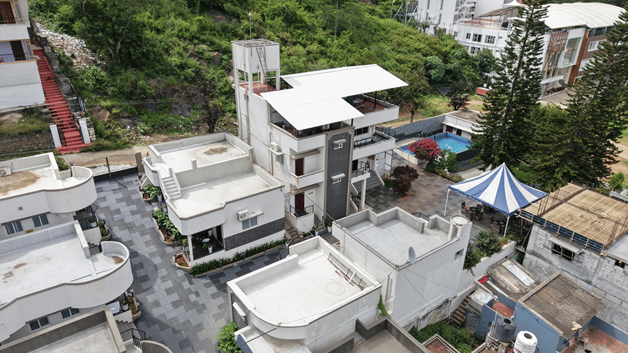 Closely arranged multi-story residential buildings and roads. | WOW Naturefull Resorts, Yercaud