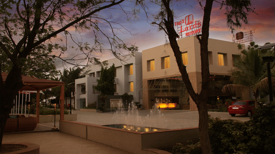 facade of Top3 Lords Resort Bhavnagar overviewing the gazebo with a small waterfall besides under a beautiful sky