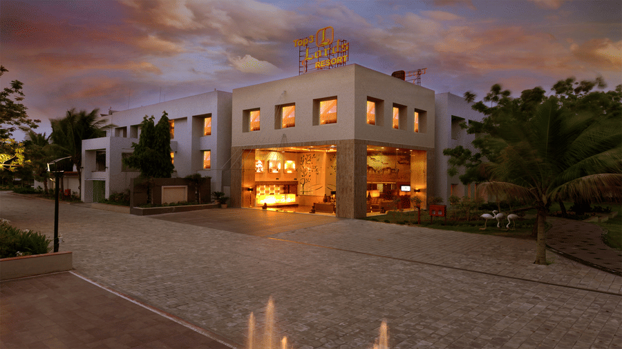facade of Top3 Lords Resort Bhavnagar with a spacious pathway and trees beside the hotel building