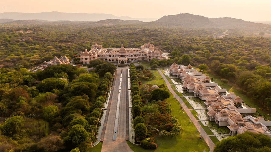 Aerial view of Evolve Back Hampi resort surrounded by lush greenery and Deccan plateau