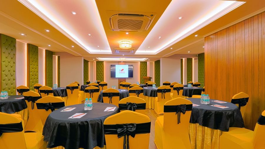 Close-up view of a meeting room setup with round tables and chairs.
