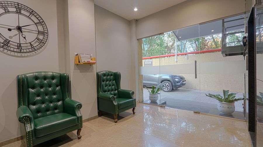 alt-text An image of a recepetion lobby with two sofa chairs  near that there is an entrance glass door - Fortune House, Magarpatta
