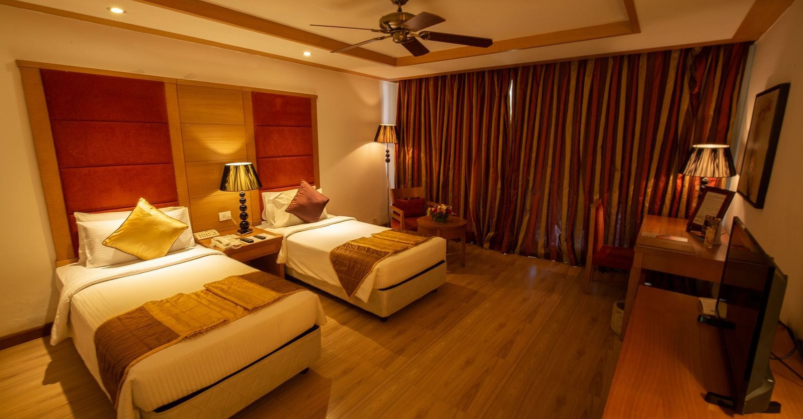 OS-FERNS room with twin beds and a TV at Ocean Spray Puducherry 