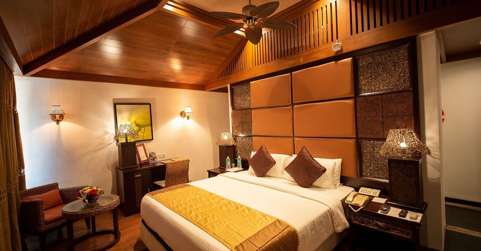 a double bed inside BERMUDA Villa Wooden themed bedroom at Ocean Spray Puducherry