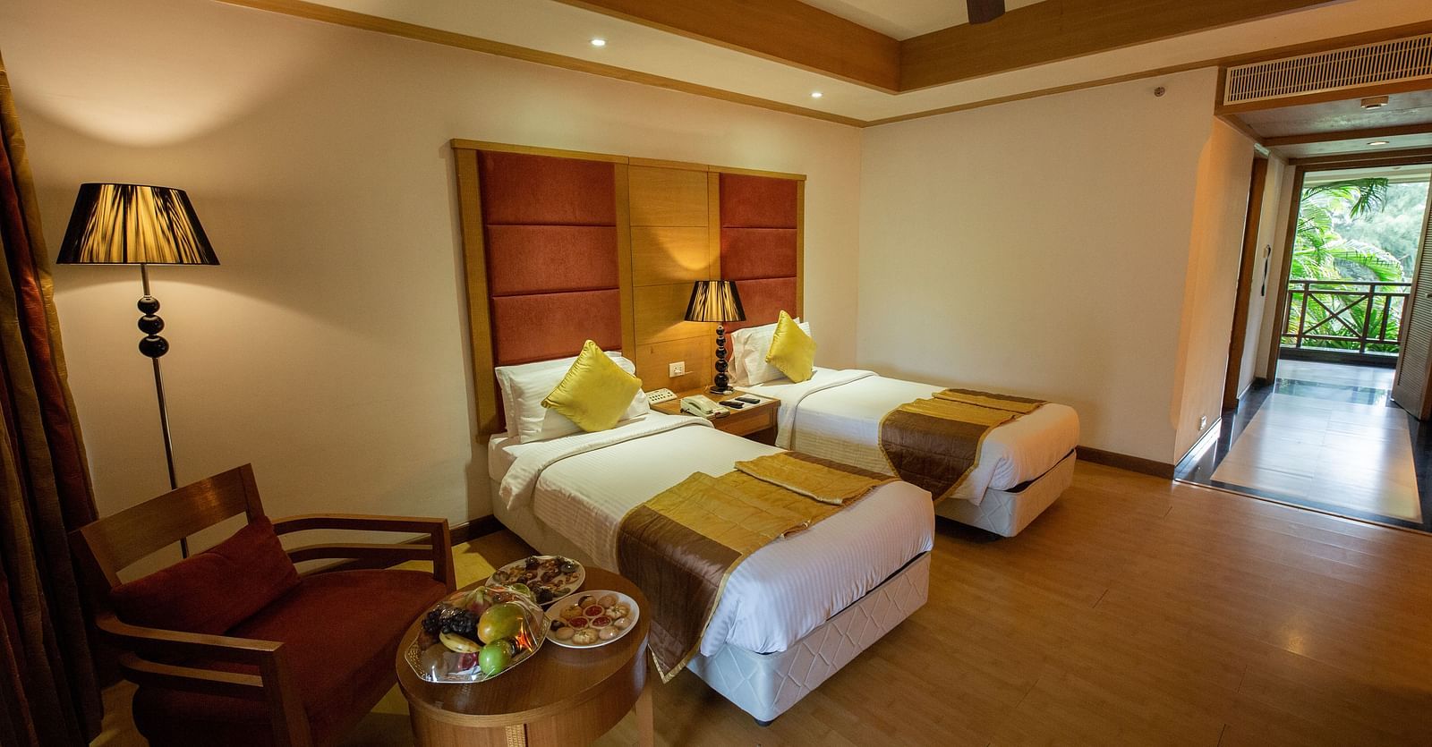OS-CASCADE room with twin bed and wooden headboard at Ocean Spray Puducherry