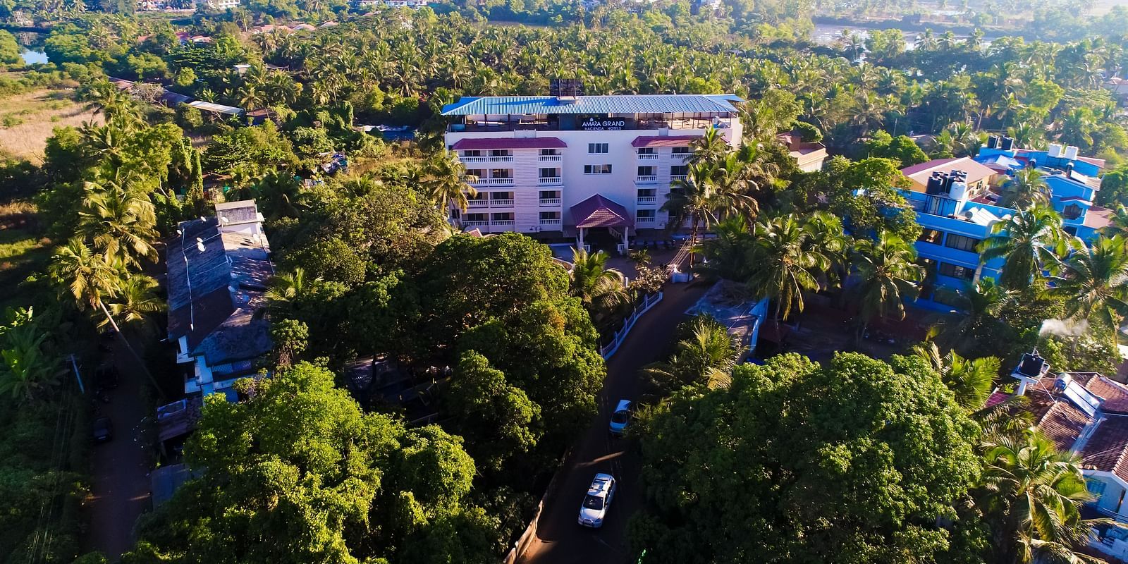 Aerial view of Calux Grand Baga with buildings and trees surrounding it.