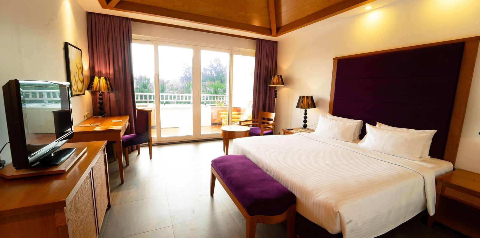 Heavens Room Interior with comfortable bed and ceiling to floor windows at Ocean Spray, Pondicherry 