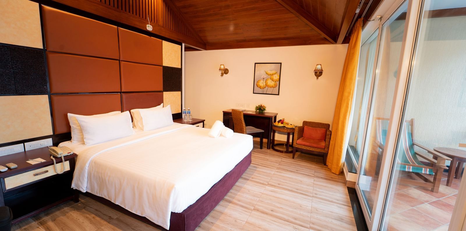 Santorini Villa with a balcony, queen size bed and wooden headboard at Ocean Spray Puducherry