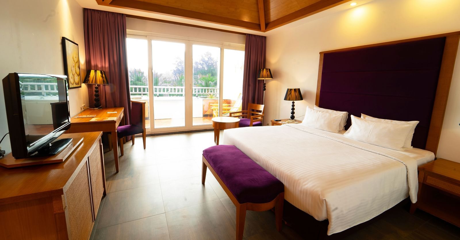 Heavens Room Interior with comfortable bed and ceiling to floor windows at Ocean Spray, Pondicherry 