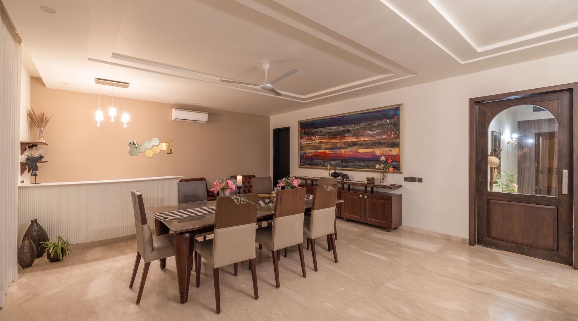 Elegant indoor dining hall with modern seating and ambient lighting at Karma Chalets.