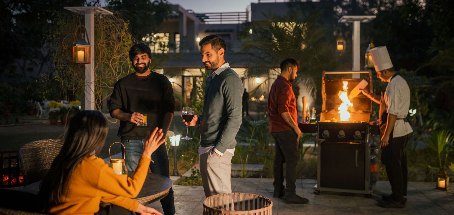 Guests enjoying a cozy bonfire gathering in the outdoor space at Karma Chalets.