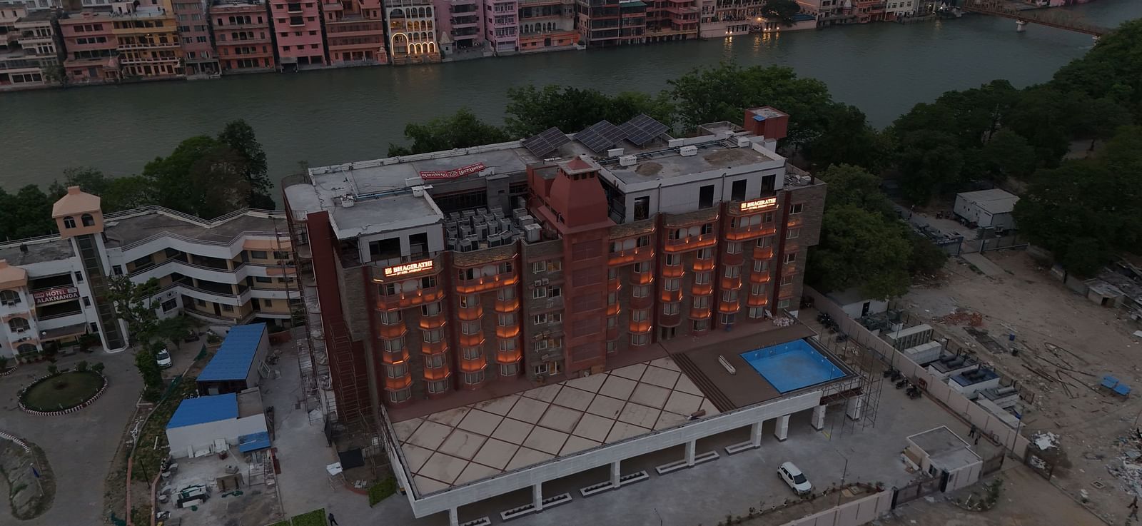 A bird's eye view of Bhagirathi by RDB Atishay featuring the exterior of the hotel with the Ganges flowing behind it.
