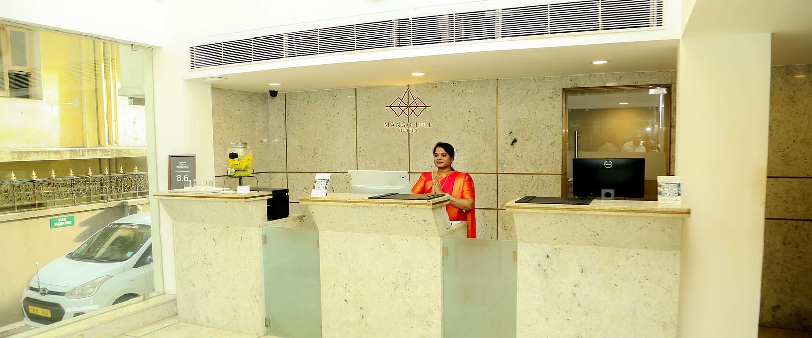 Reception area of Mango Hill Central, Chennai featuring a lady at the reception desk