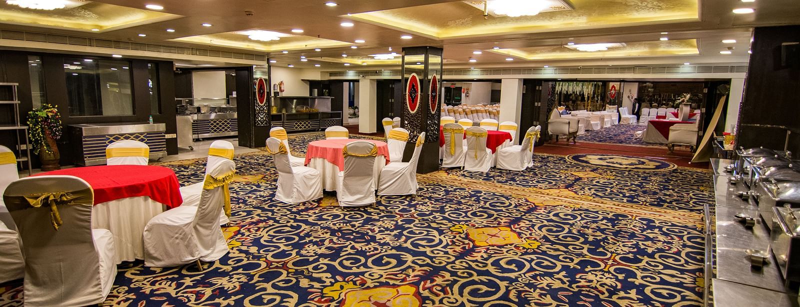 Maurya featuring round tables around chairs with patterned flooring and decorative ceilings.