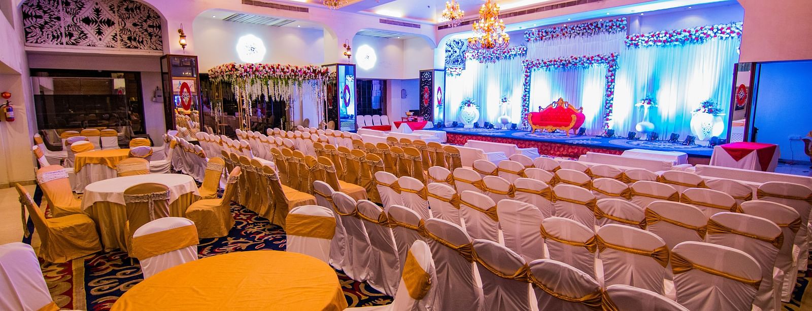 Kohinoor displaying rows of chairs and tables ready for an event, with a view of the stage.