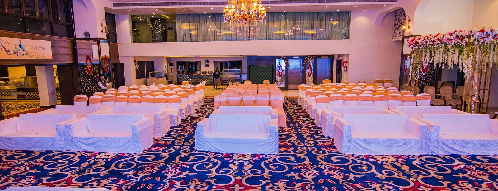 Kohinoor featuring blue patterned carpet and rows of chairs.