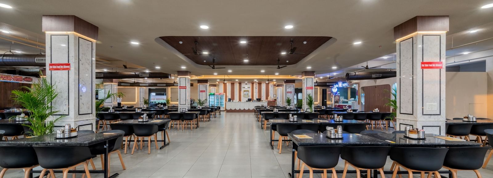 Spacious restaurant with ample seating, bright interiors, and welcoming ambience at Hotel Highway King, Neemrana.