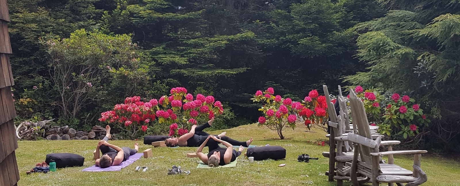A private yoga session on a well manicured lawn surrounded by lush greenery | Brewery Gulch Inn & Spa