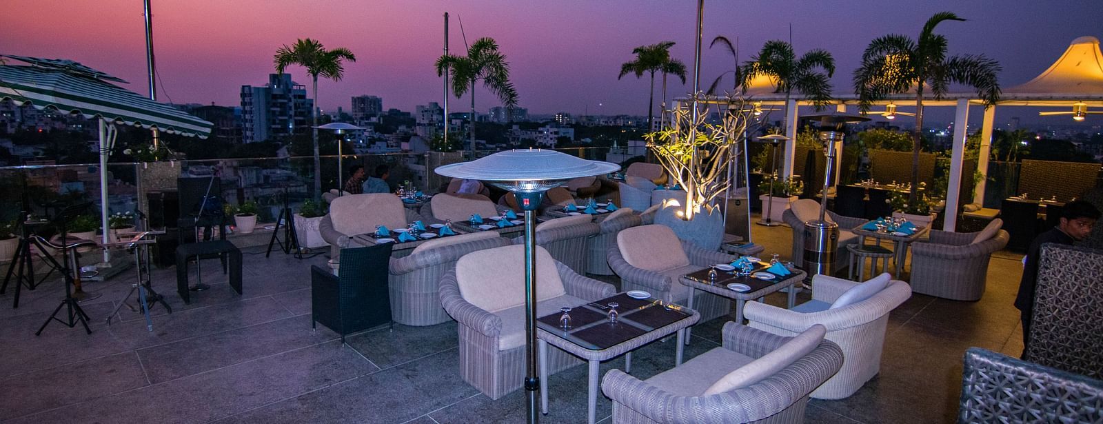 An outdoor dining setup at dusk at Hotel Ashok Nagpur.