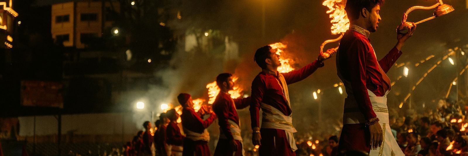 priests lined up performing ganga arti in the late evening at rishikesh