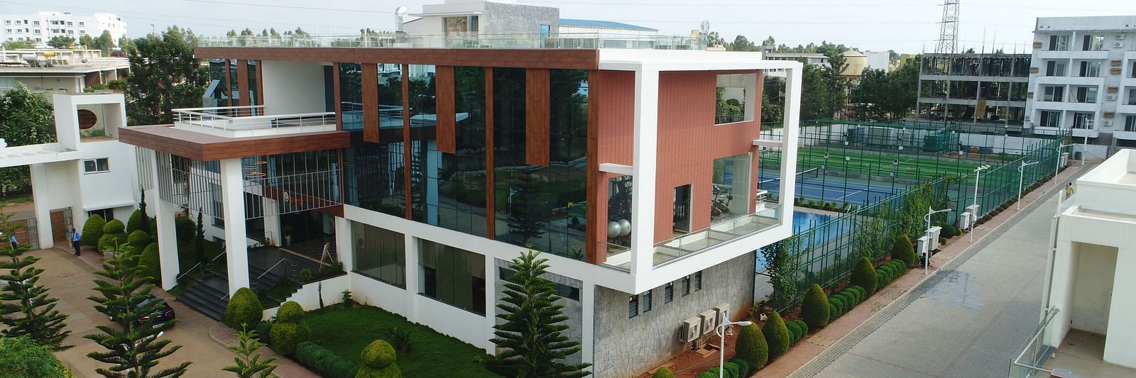 An aerial shot of the facade of the hotel with a cloudy sky in the background - Welcome Inn Hotels