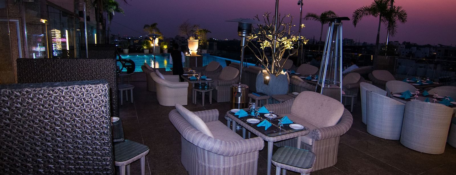 An outdoor furniture setup of a restaurant at Hotel Ashok Nagpur.