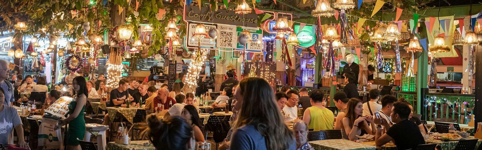 A street filled with people having drinks 