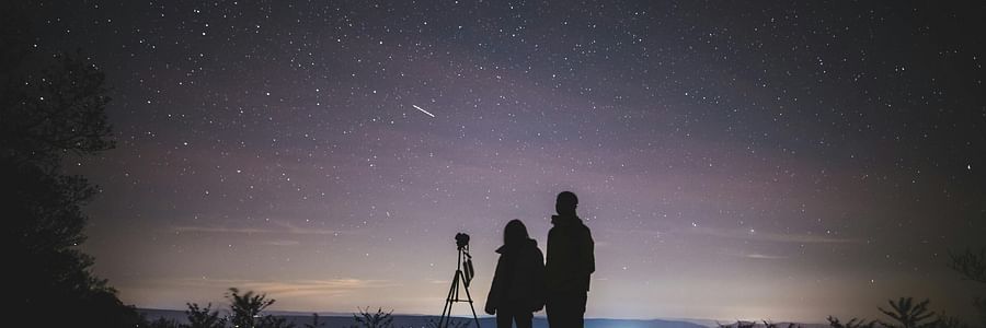 Couple star gazing with a camera.