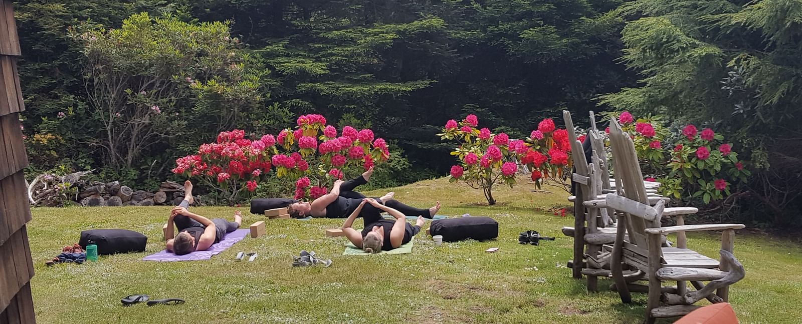 A private yoga session on a well manicured lawn surrounded by lush greenery | Brewery Gulch Inn & Spa