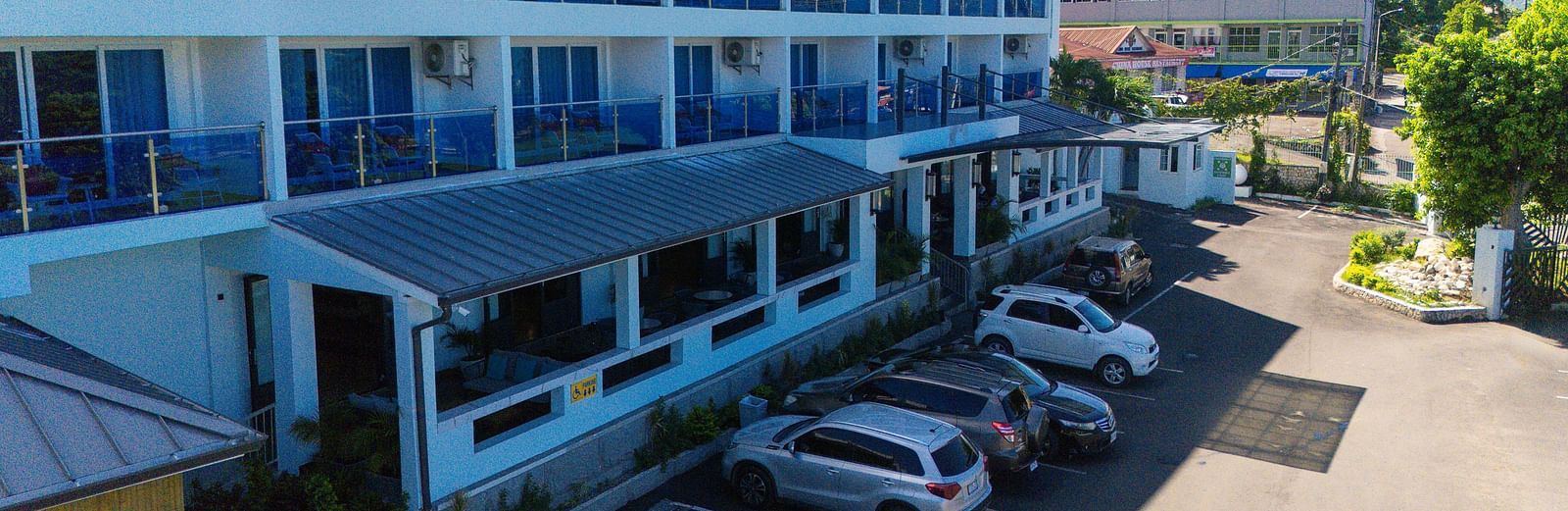 A drone shot of our Hotel 39 @ Jamaica with cars parked in front of it - Hotel 39, Jamaica (Montego Bay)