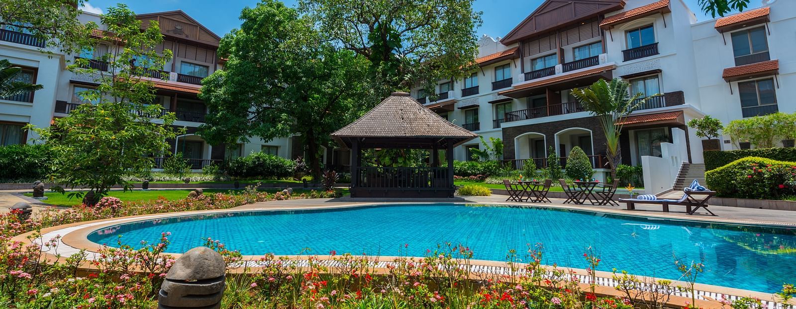 an image of a swimming pool in front of the resort - Rhythm Lonavala
