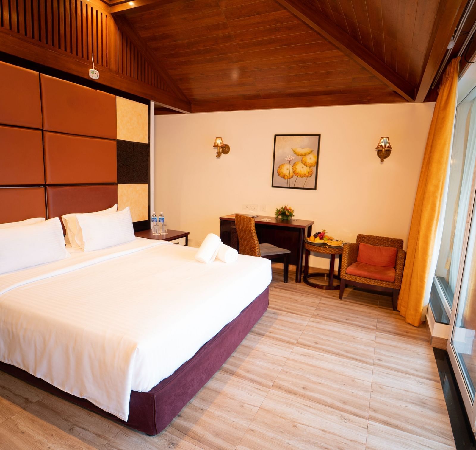 Santorini Villa with a balcony, queen size bed and wooden headboard at Ocean Spray Puducherry