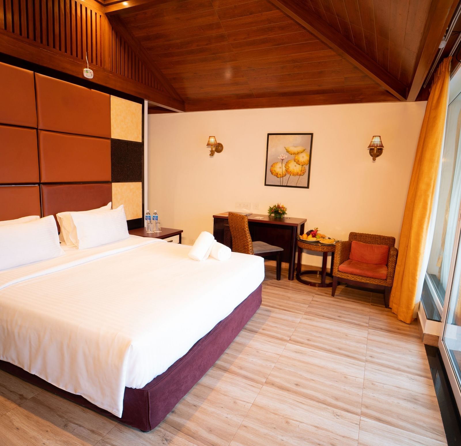 Santorini Villa with a balcony, queen size bed and wooden headboard at Ocean Spray Puducherry