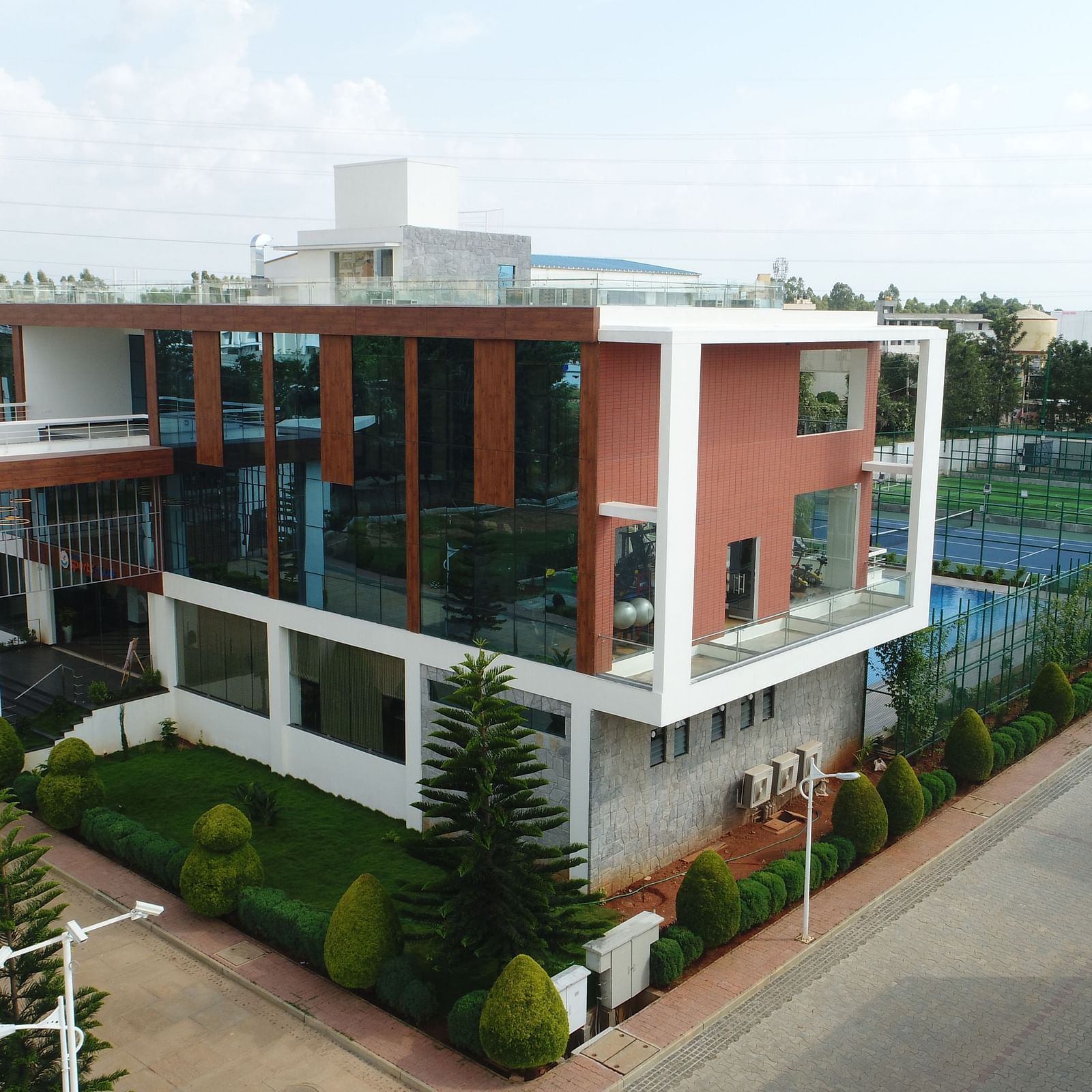 An aerial shot of the facade of the hotel with a cloudy sky in the background - Welcome Inn Hotels