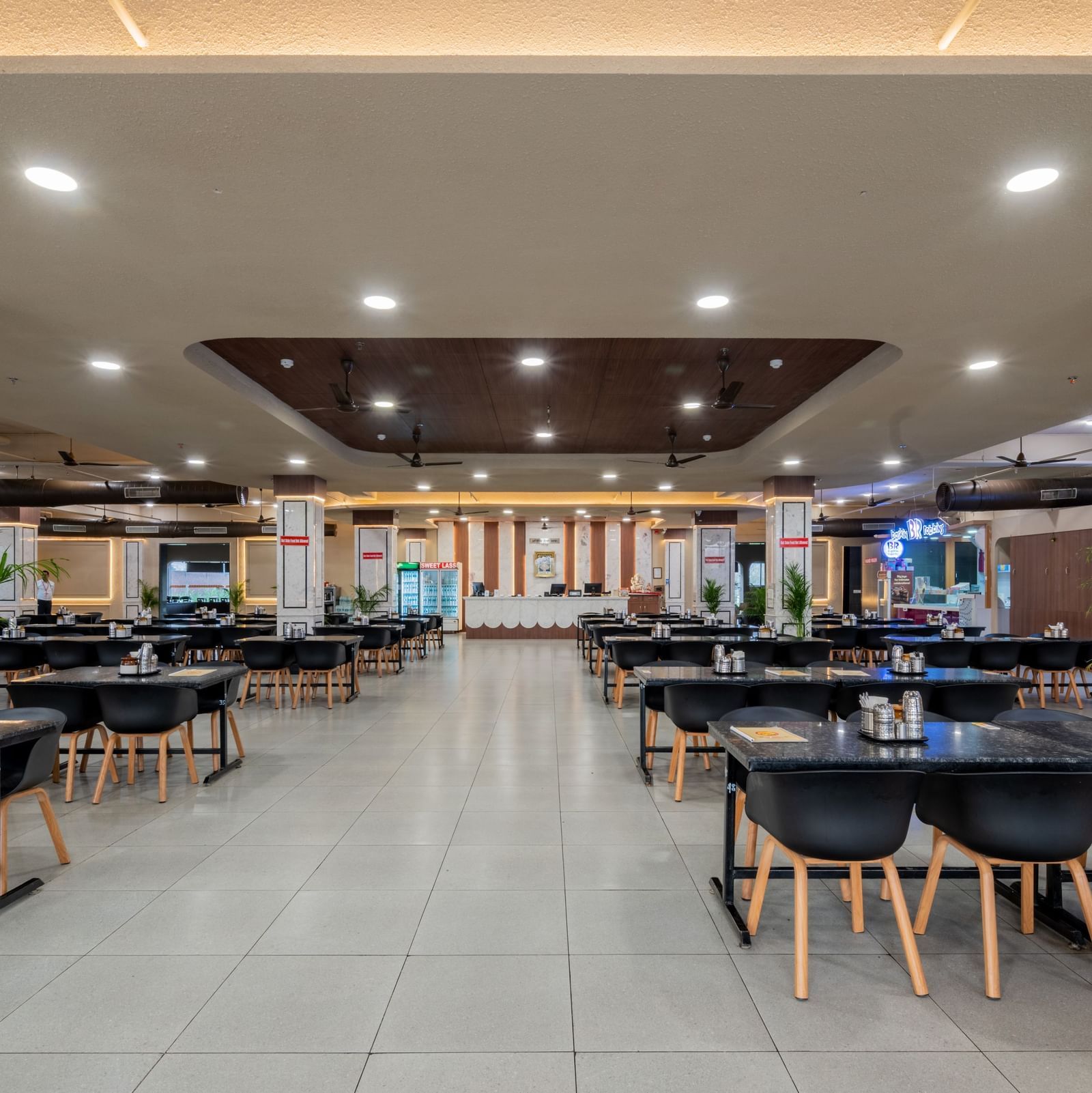 Spacious restaurant with ample seating, bright interiors, and welcoming ambience at Hotel Highway King, Neemrana.