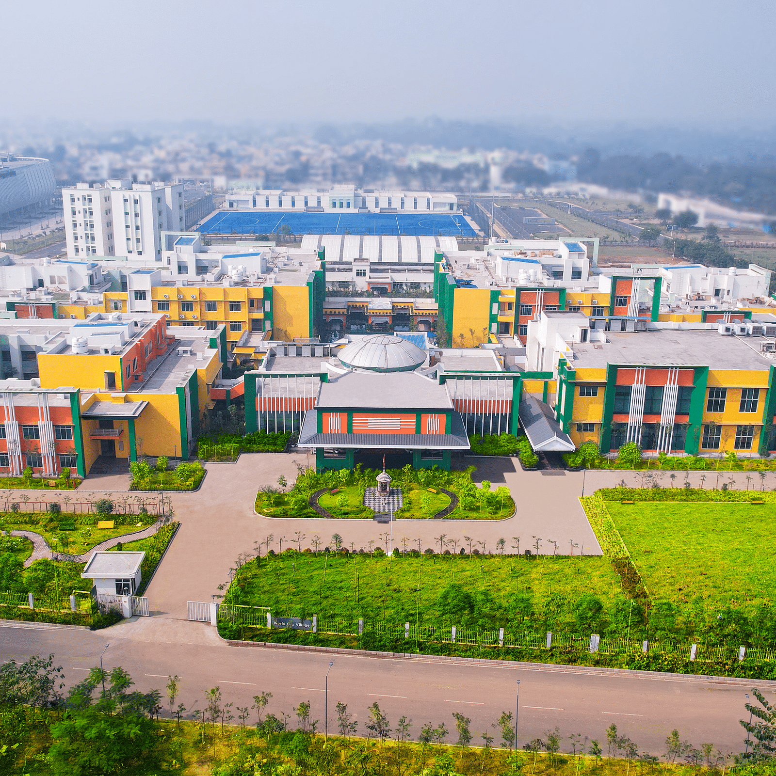Aerial view of Mayfair World Cup Village, Rourkela, showcasing the vibrant and expansive facade of the hotel complex.
