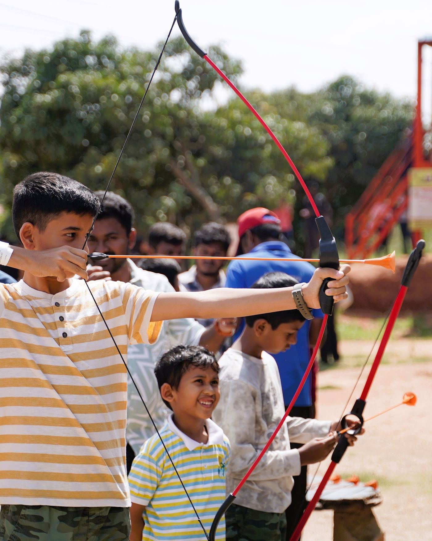 An image of a teen boy along with a little boy playing archery at Ravishing Retreat