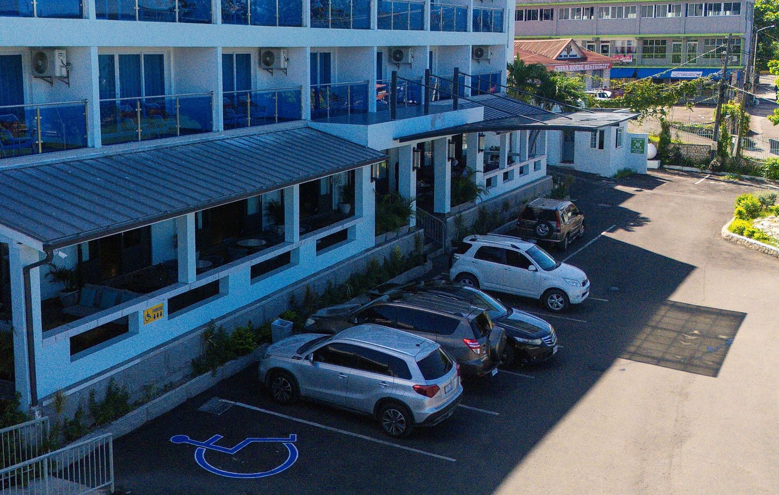 A drone shot of our Hotel 39 @ Jamaica with cars parked in front of it - Hotel 39, Jamaica (Montego Bay)