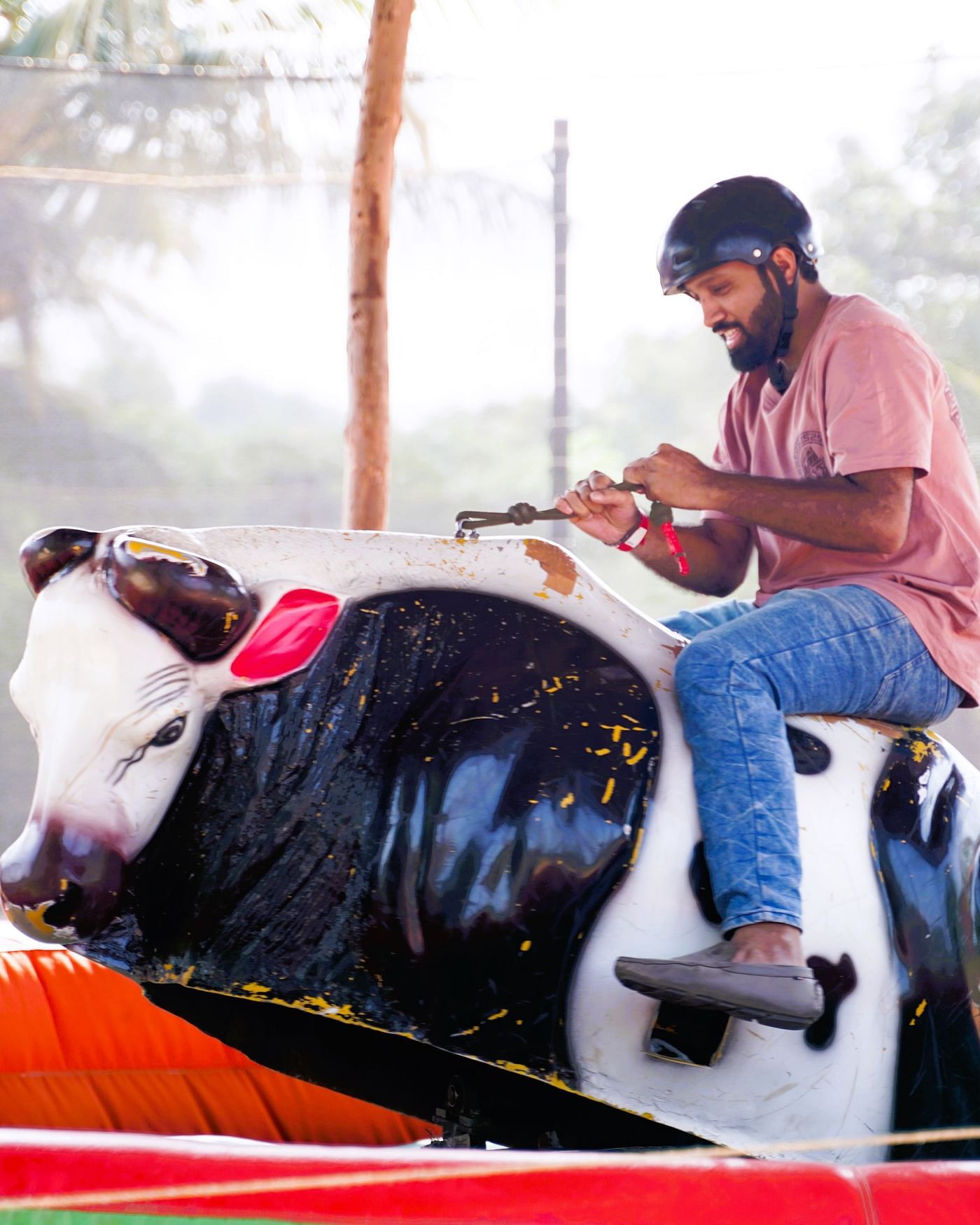 A person enjoying bull ride at Ravishing Retreat on a sunny day