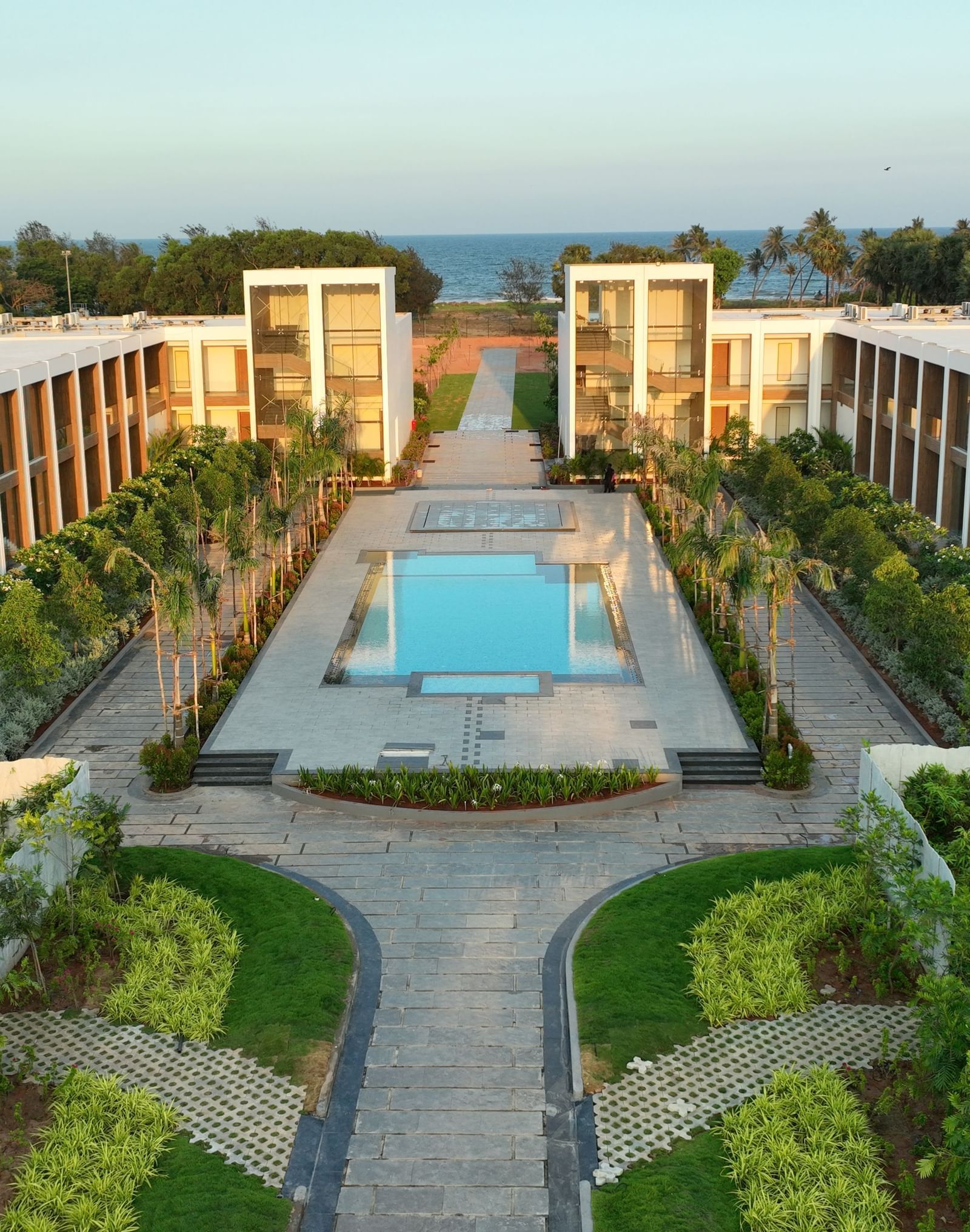 A top angle shot of the exterior of The Shore Trishvam, Pondicherry with a common swimming pool in the middle.