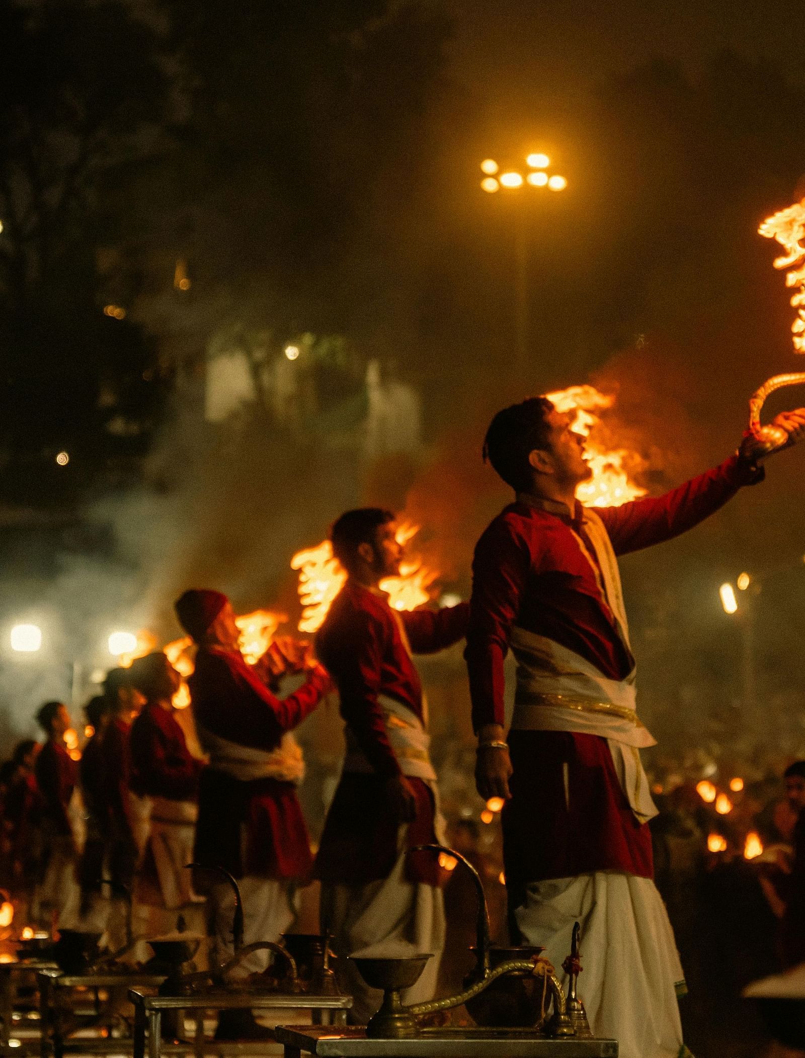 priests lined up performing ganga arti in the late evening at rishikesh
