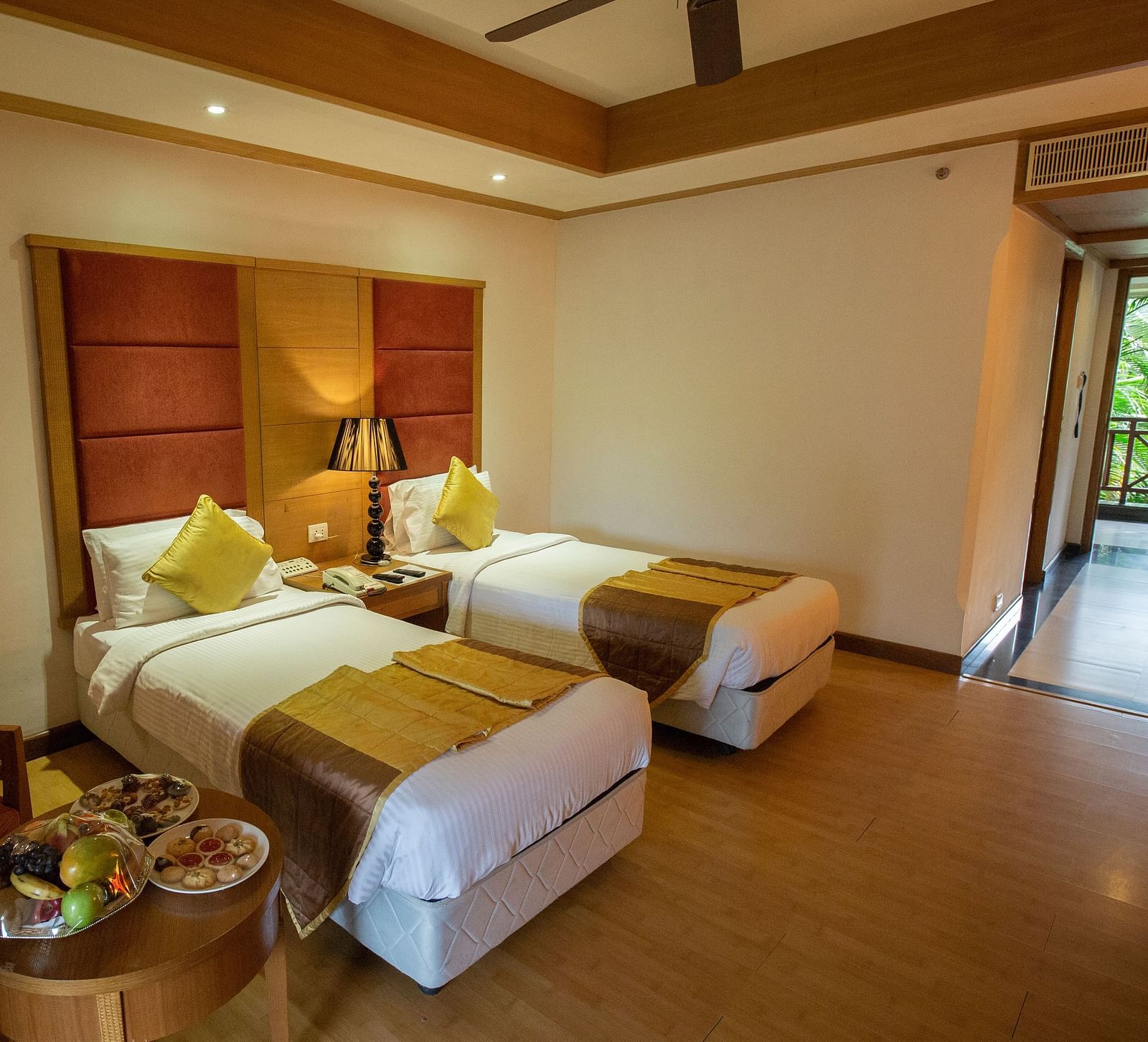 OS-CASCADE room with twin bed and wooden headboard at Ocean Spray Puducherry