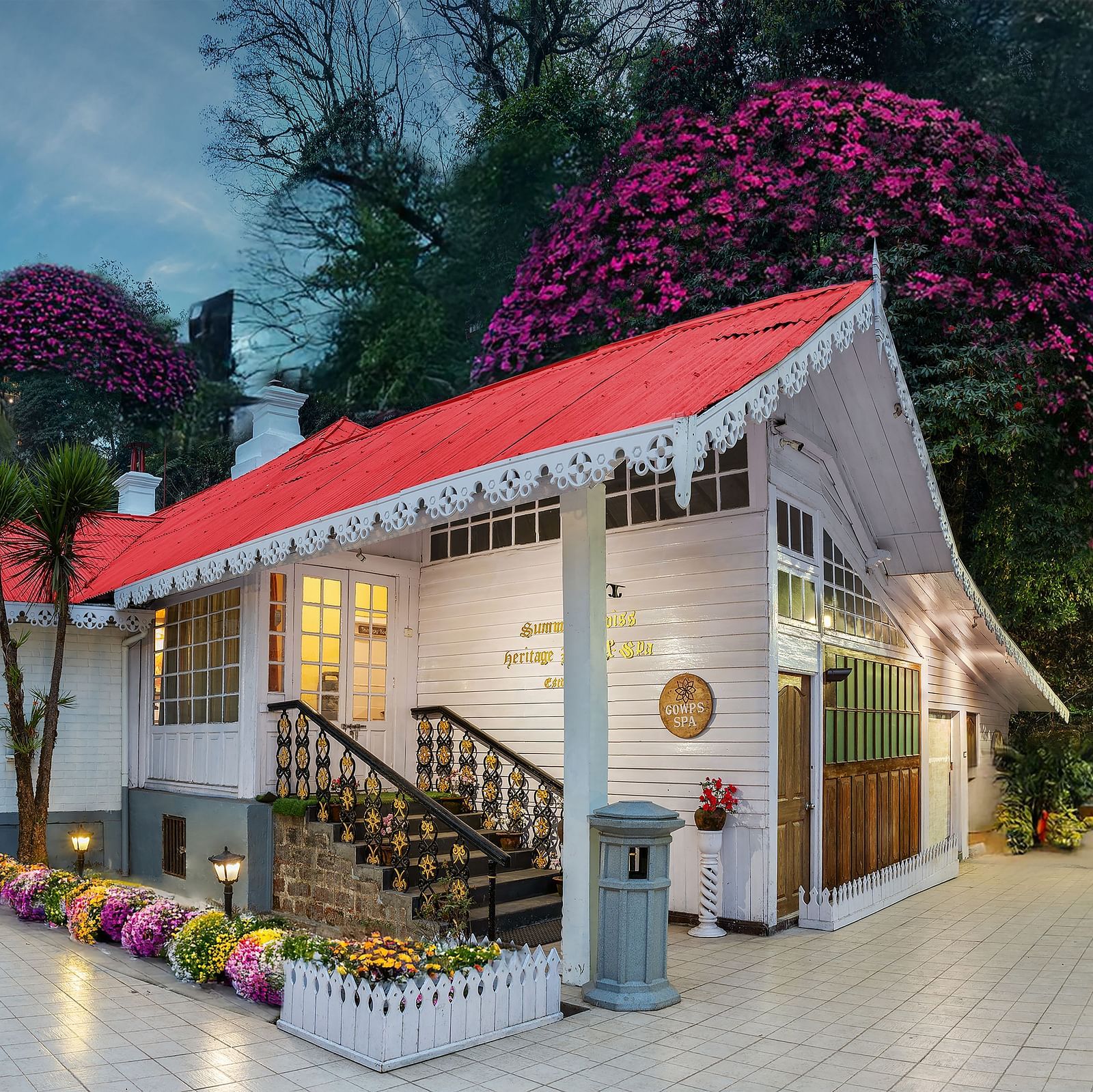 Facade view of Summit Swiss Heritage Resort & Spa, Mall Road, featuring the entrance, outdoor seating, and lush trees surrounding the property