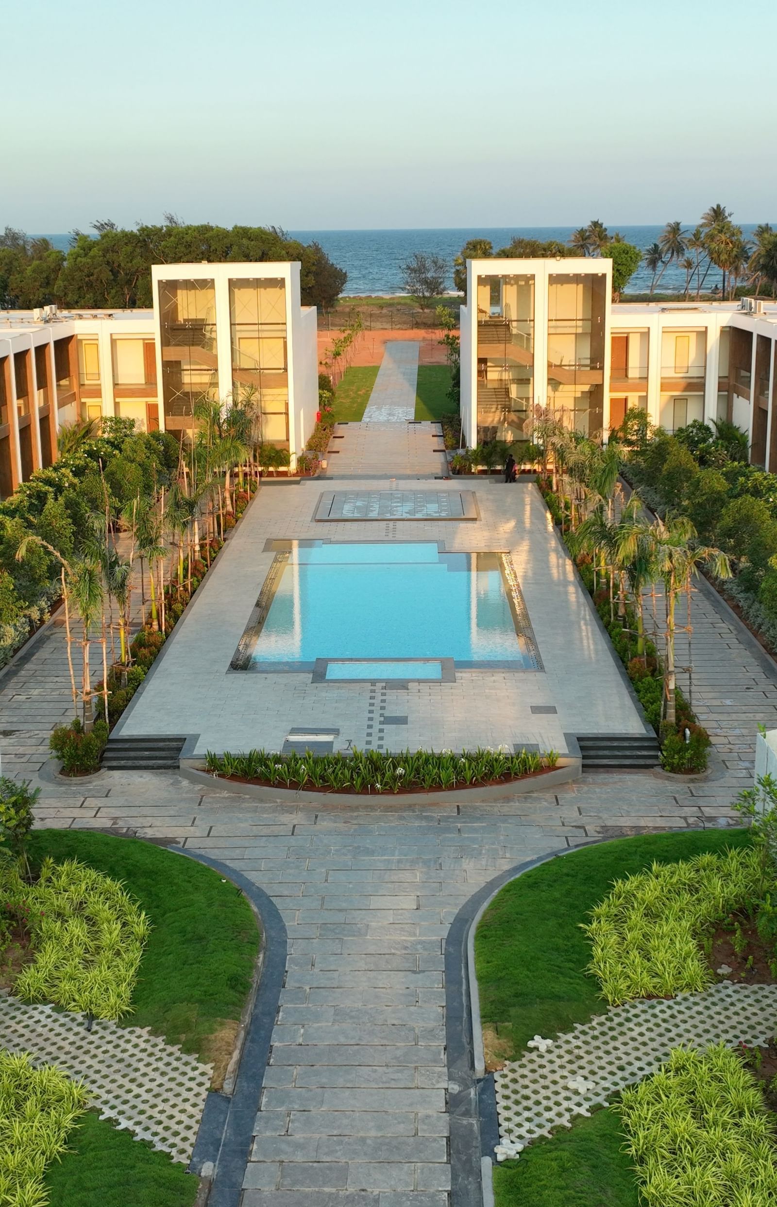 A top angle shot of the exterior of The Shore Trishvam, Pondicherry with a common swimming pool in the middle.