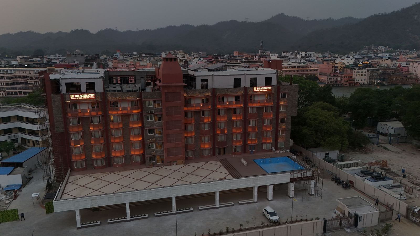 DJI 20250501211435 0039 D (1)Drone shot of the exterior of Bhagirathi by RDB Atishay during the evening hours with a mountain ranges in the background.