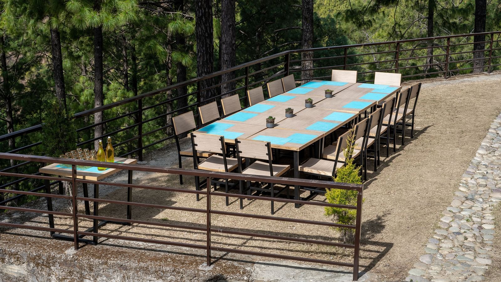 An outdoor lawn featuring a long table surrounded by chairs at BluSalzz Escapade Resort, Lansdowne.